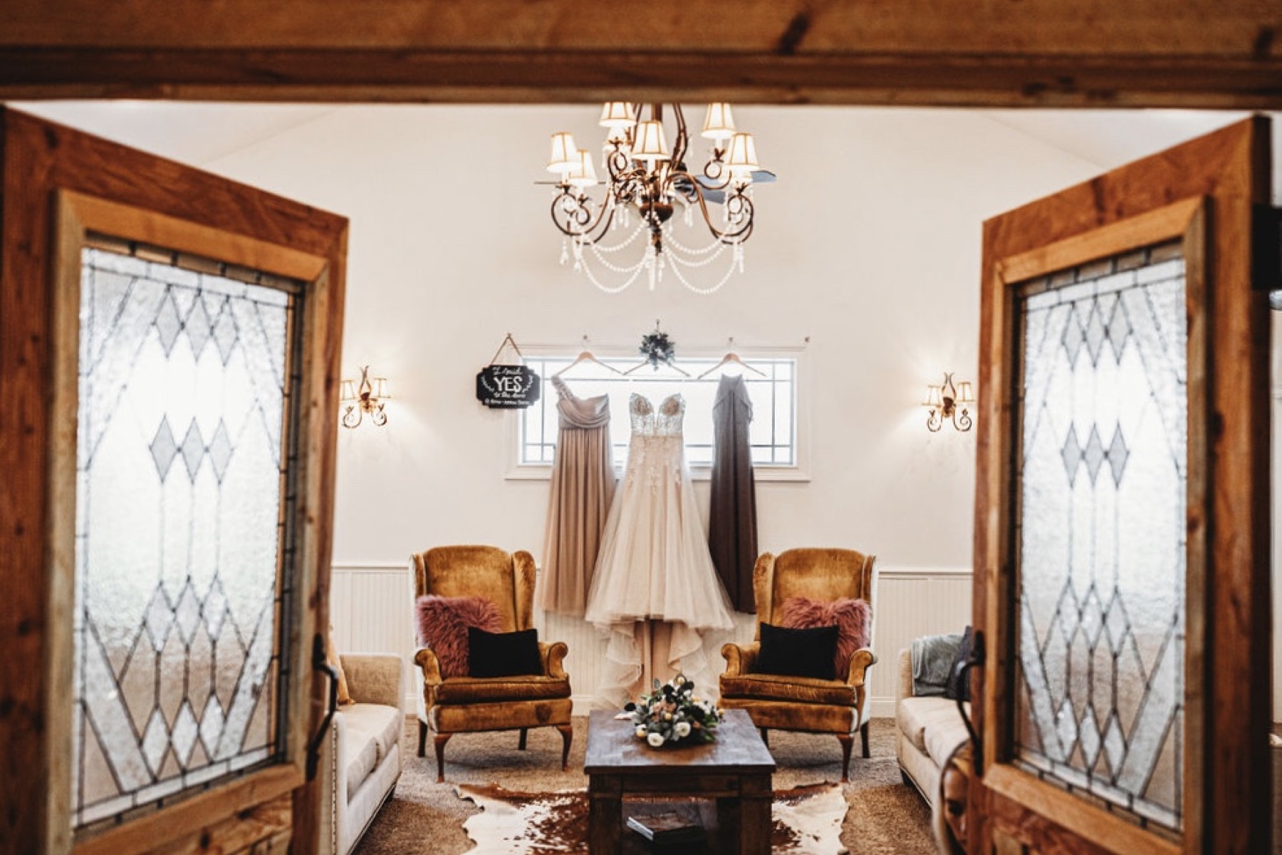 The main hall inside the cedar barn with chandeliers and curved staircase